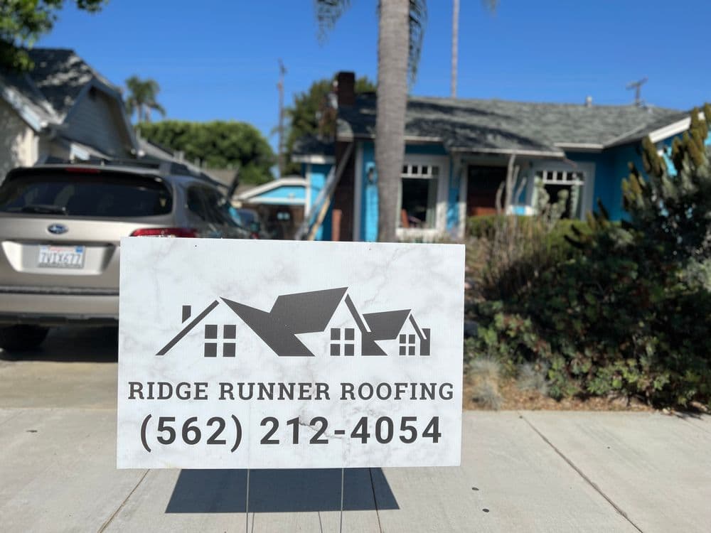 Ridge Runner Roofing sign in front of a residential home, with contact number 562-212-4054.